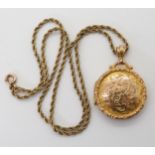 A 9ct gold circular locket hallmarked Birmingham 1911, monogram to the back, with a yellow metal