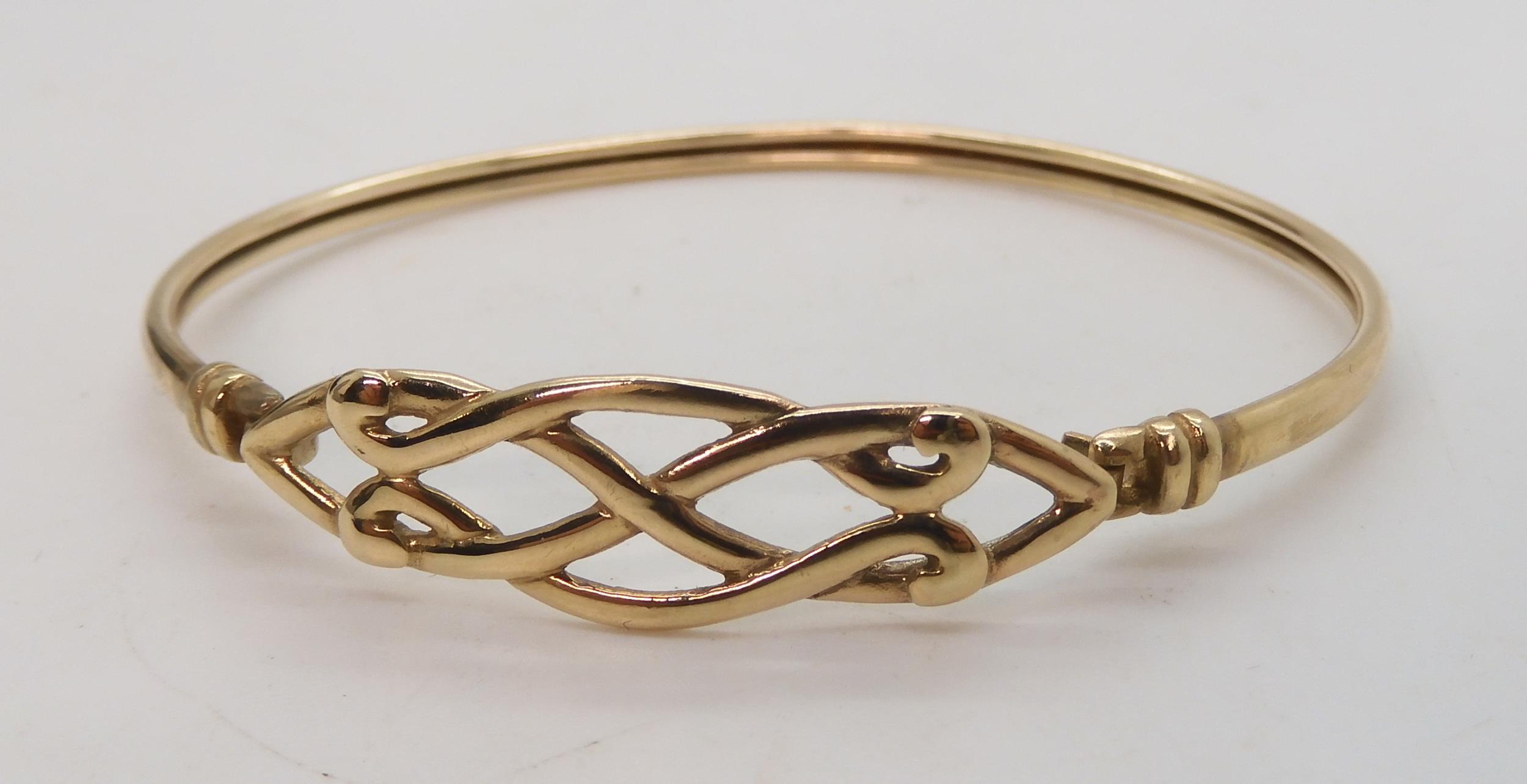 A 9ct gold knotwork bangle together with two pairs of earrings weight together 8.2gms Condition - Image 2 of 3