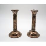 A pair of silver candle sticks (weighted), by Joseph Gloster Ltd, Birmingham 1917, modelled as