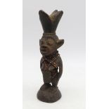 A West African carved wood and beaded fetish figure  Condition Report:Available upon request