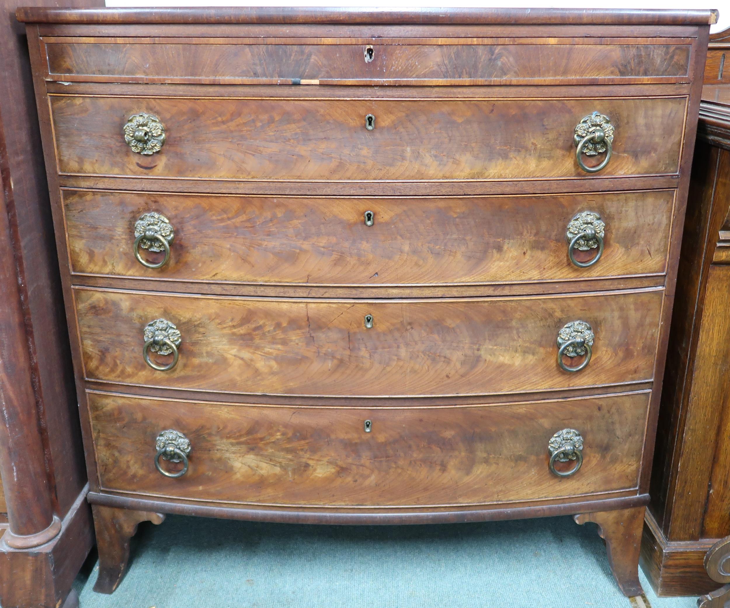 A Victorian mahogany bow front chest of five drawers with single frieze drawer over four regular,