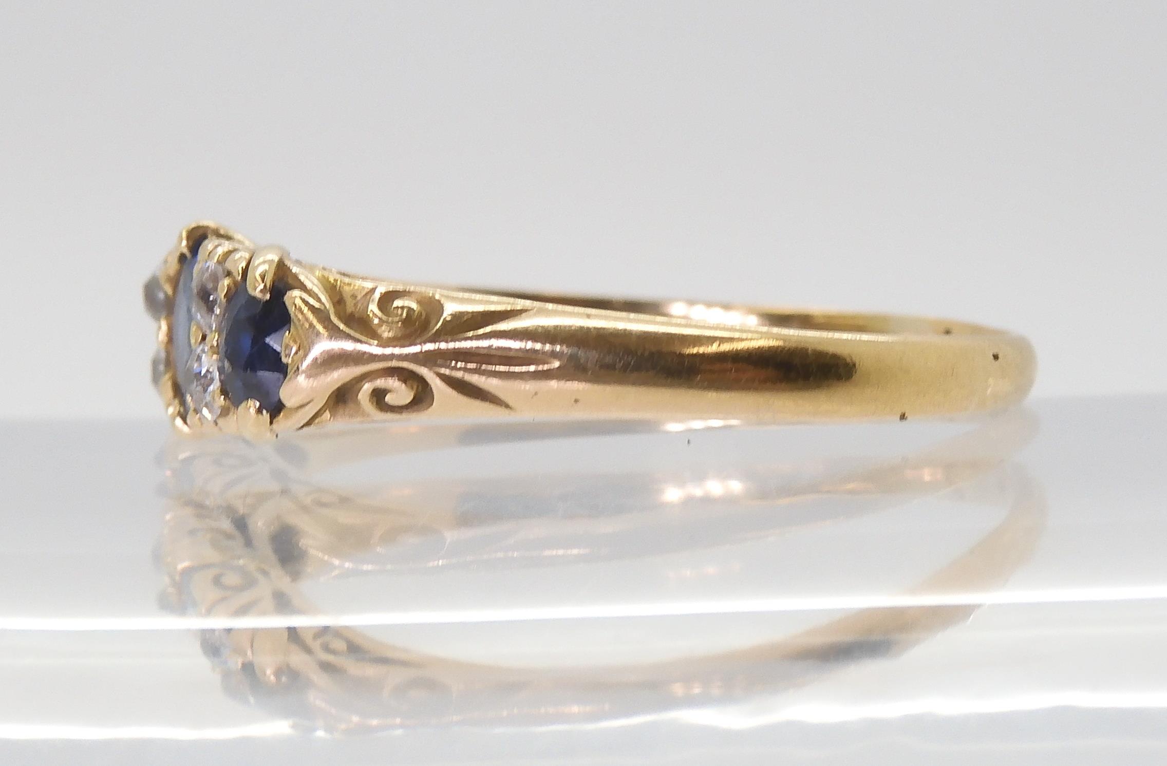 A yellow metal sapphire and diamond ring, in a classic scroll mount, finger size U1/2, weight 3.3gms - Image 3 of 3