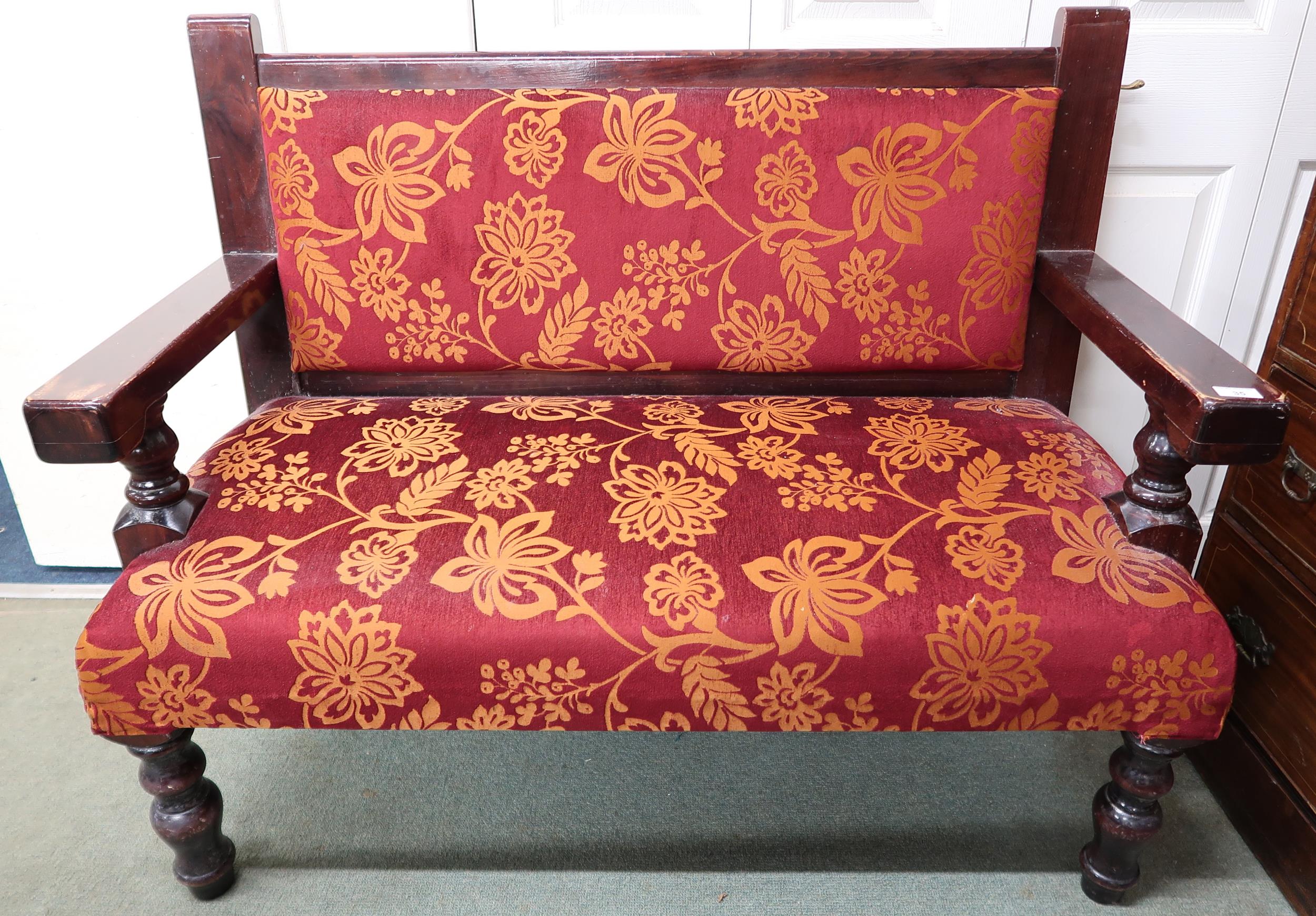 A 20th century floral upholstered pub settle on turned supports, 97cm high x 120cm wide x 57cm