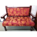 A 20th century floral upholstered pub settle on turned supports, 97cm high x 120cm wide x 57cm