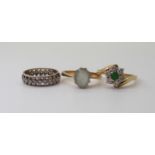 A 9ct gold aquamarine ring, size O, a 9ctgold clear and green gem set flower ring, size O1/2, and