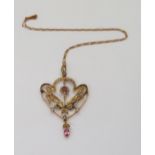 A large Edwardian pendant set with pink gems and pearls, on a 9ct gold fancy chain,length 39cm,
