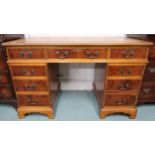 A 20th century mahogany twin pedestal writing desk with embossed leather skiver over single drawer