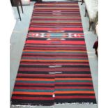 An approximate pair of Zapotec Mexican rugs with geometric central medallion on multicoloured