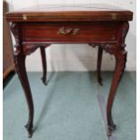 A 20th century mahogany envelope card table with four fold top concealing green baize play surface