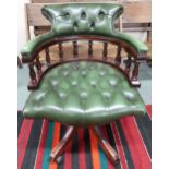 A 20th century green leather button back upholstered captains style swivel desk chair, 86cm high x