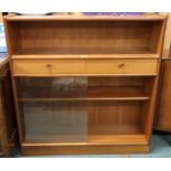 A mid 20th century teak bookcase with open shelf over two drawers over glass sliding doors, 108cm