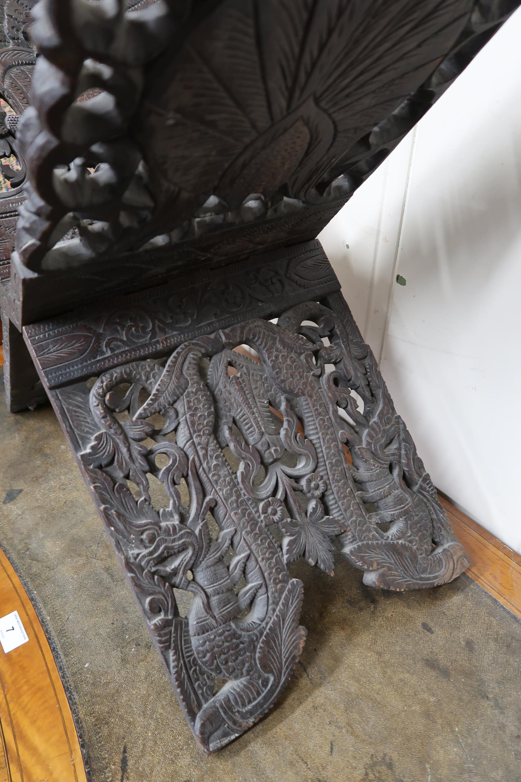 An early 20th century Burmese style folding stool extensively carved with peacocks, a carved game - Image 5 of 6