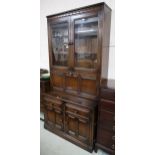 A 20th century Ercol elm and beech bureau bookcase with pair of glazed doors over fall front