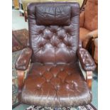 A mid 20th century brown leather button backed upholstered swivel armchair on steel base, 92cm