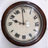 An early 20th century oak cased station style wall clock with white dial bearing Roman numerals,