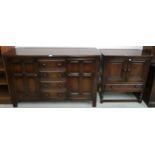 A 20th century Ercol stained elm and beech sideboard with three central drawers flanked by panel