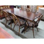 A mid 20th century Ercol elm and beech extending dining table, 75cm high x 115cm long(175cm