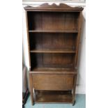 An early 20th century oak open bookcase with three open shelves over fold down surface, 132cm high x