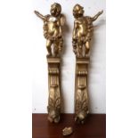 A pair of 20th century gilt gesso scrolled ogee wall mounts capped with figural cherubs, 78cm