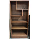 A 20th century Wylie Lochhead ltd oak open bookcase with two asymmetrical shelves over three regular