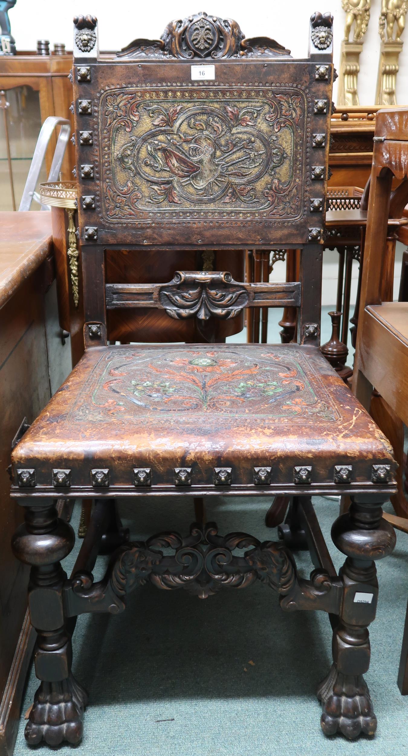 A Victorian stained oak framed Baronial style hall chair with leather back and seat embossed with