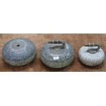 A pair of Scottish polished curling stones with detached handles and another smaller curling