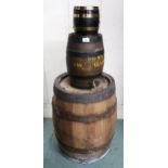 An ironed banded coopered barrel, a smaller coopered wine cask with spigot and a small brass