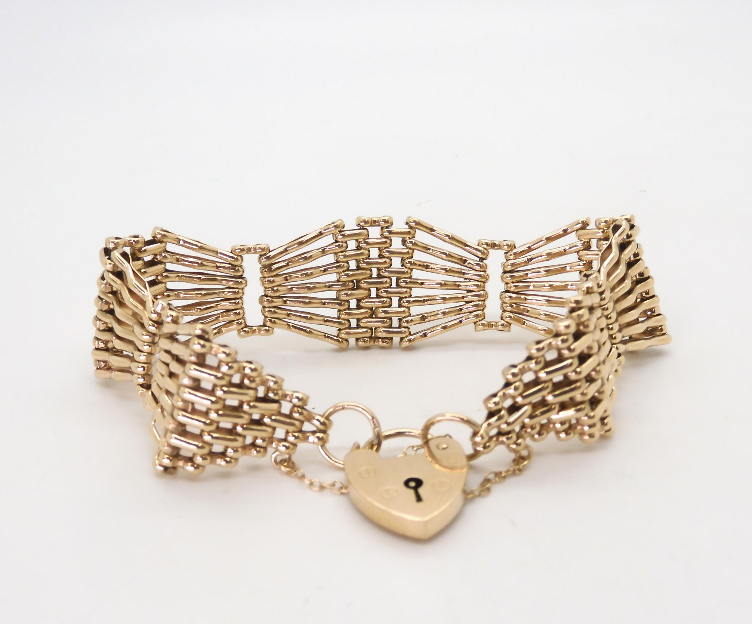 A 9ct gold wide gate bracelet with heart shaped clasp, length approx 18cm, width2cm, weight 29.