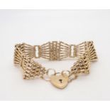 A 9ct gold wide gate bracelet with heart shaped clasp, length approx 18cm, width2cm, weight 29.