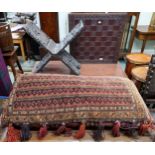 An early 20th century Burmese style folding stool extensively carved with peacocks, a carved game