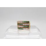 An 18k gold emerald and clear gem four part ring, finger size Q, weight 5.4gms Condition Report:
