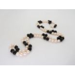 An opera length of good quality pearls, onyx and gold beads, length 88cm Condition Report: