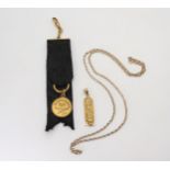 An Arabic gold Egyptian hieroglyph pendant, weight 2.3gms, a belcher chain, length 56cm, and a