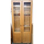 A pair of contemporary Ercol elm and beech glazed tall bookcases, 213cm high x 47cm wide x 31cm deep