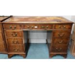 A 20th century mahogany twin pedestal writing desk with leather skiver over single central drawer
