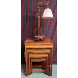 A 20th century Oriental hardwood nest of four tables and a Oriental hardwood table lamp in the