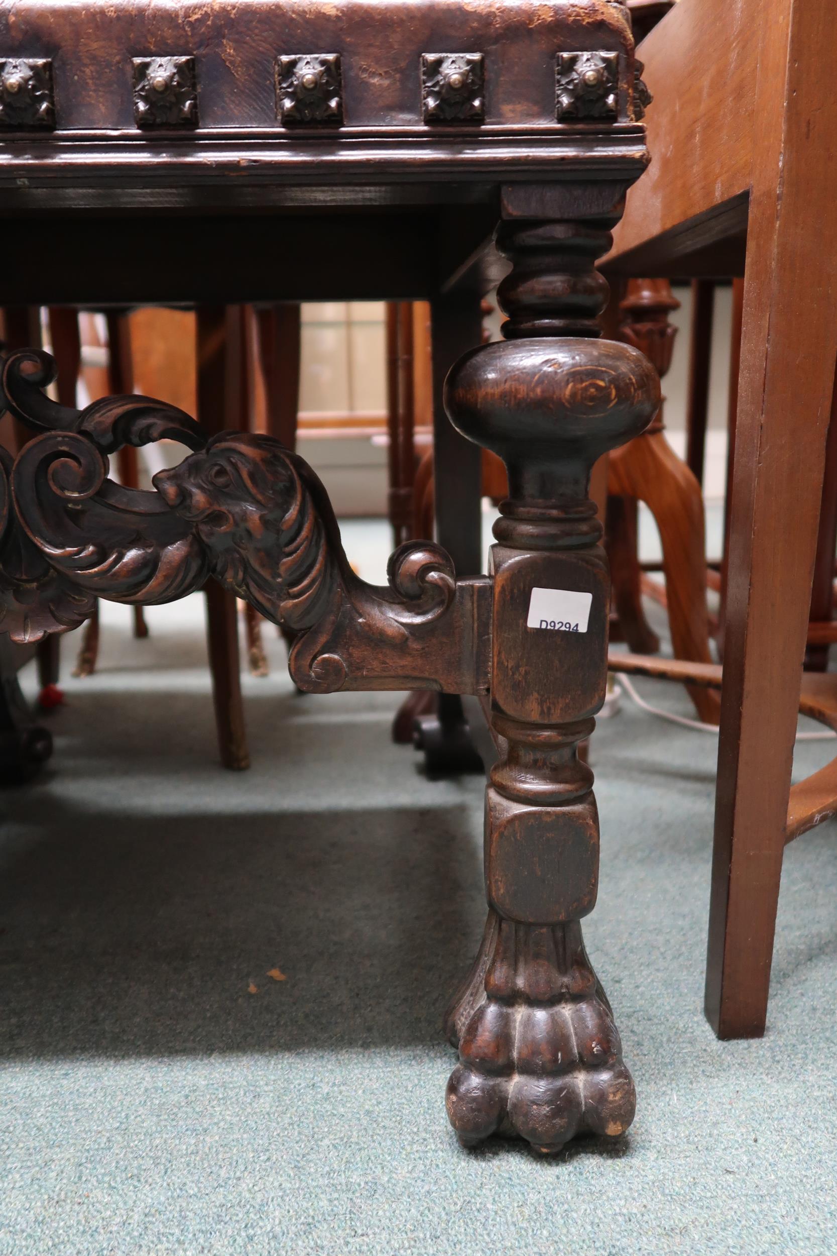 A Victorian stained oak framed Baronial style hall chair with leather back and seat embossed with - Image 4 of 4