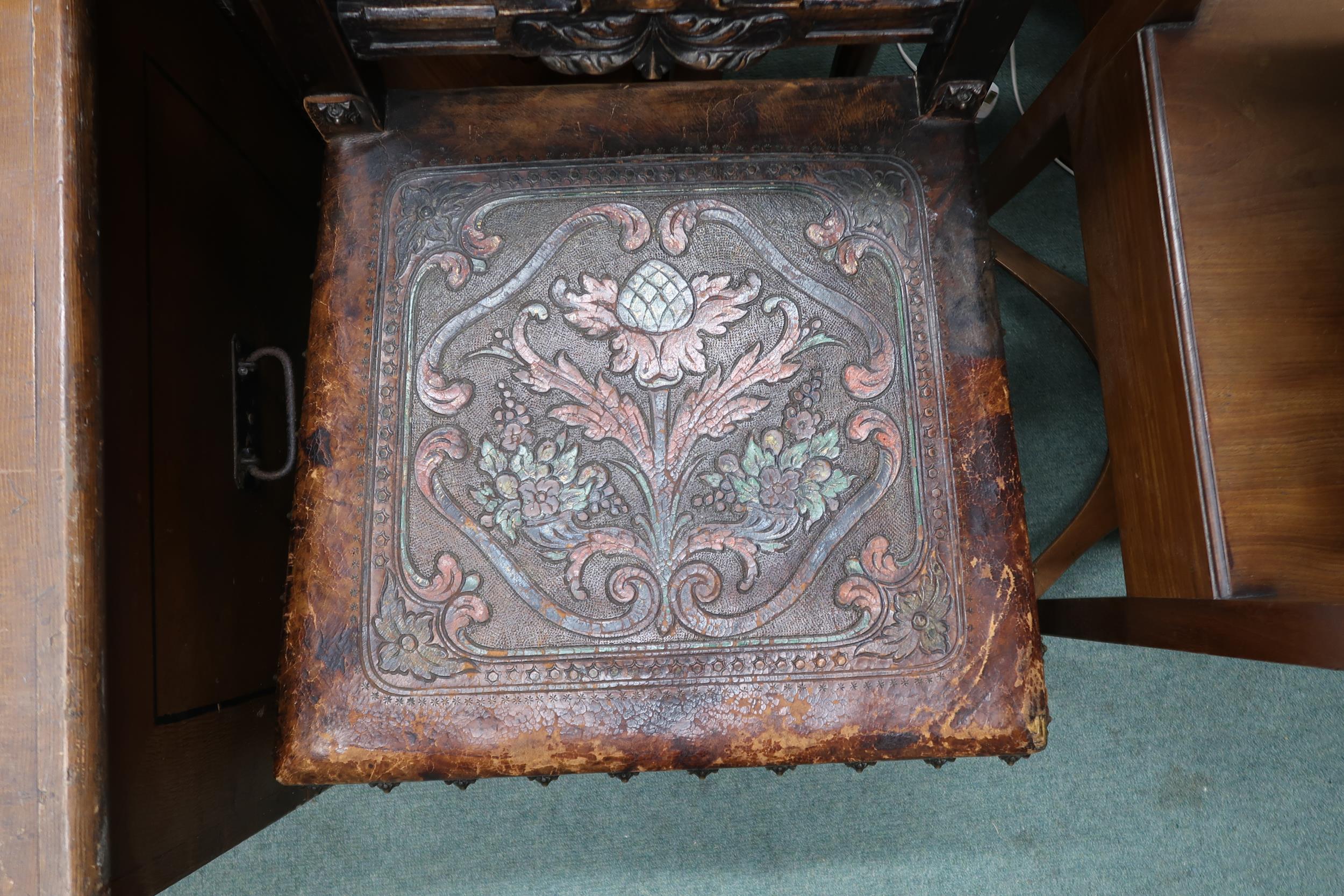 A Victorian stained oak framed Baronial style hall chair with leather back and seat embossed with - Image 3 of 4