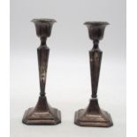 A pair of George V silver candlesticks, by Clark & Sewell, Birmingham 1917, of faceted form, with