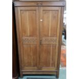 An early 20th century oak Arts and Crafts style two door wardrobe, 195cm high x 111cm wide x 44cm