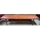 A large mid 20th century stained teak coffee table with turned supports joined by lower shelf,