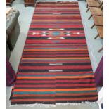 An approximate pair of Zapotec Mexican rugs with geometric central medallion on multicoloured