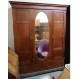 An Edwardian mahogany three door wardrobe with central mirror door, 211cm high x 162cm wide x 54cm