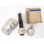 A silver cigarette case, a continental silver fob watch with an enamelled decorative dial,