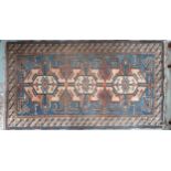 A blue ground Tibetan Kangri rug with all over geometric design and multicoloured border, 175cm long