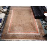A light brown ground rug with blue and terracotta border, 397cm long x 297cm wide Condition Report: