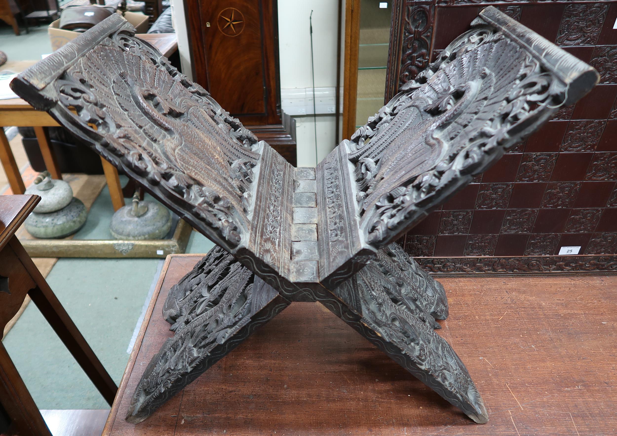 An early 20th century Burmese style folding stool extensively carved with peacocks, a carved game - Image 2 of 6