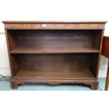 An early 20th century mahogany and walnut veneered open bookcase on bracket feet, 91cm high x