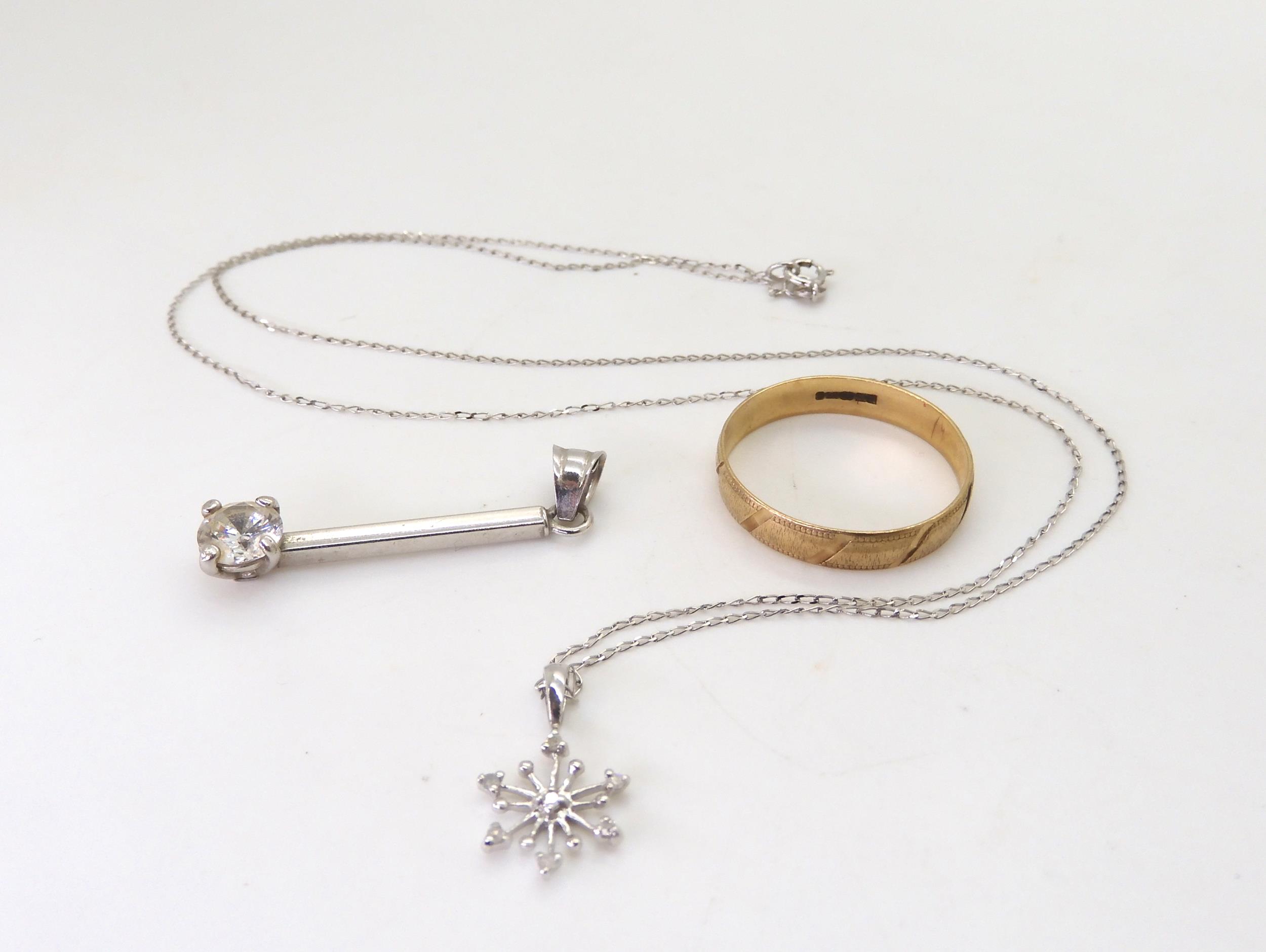 A 9ct white gold diamond set snowflake pendant, length of chain 46cm, a 9ct wedding ring size S1/