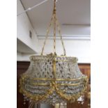 An early 20th century Louis XVI style basket chandelier with cast brass floral swags joined by